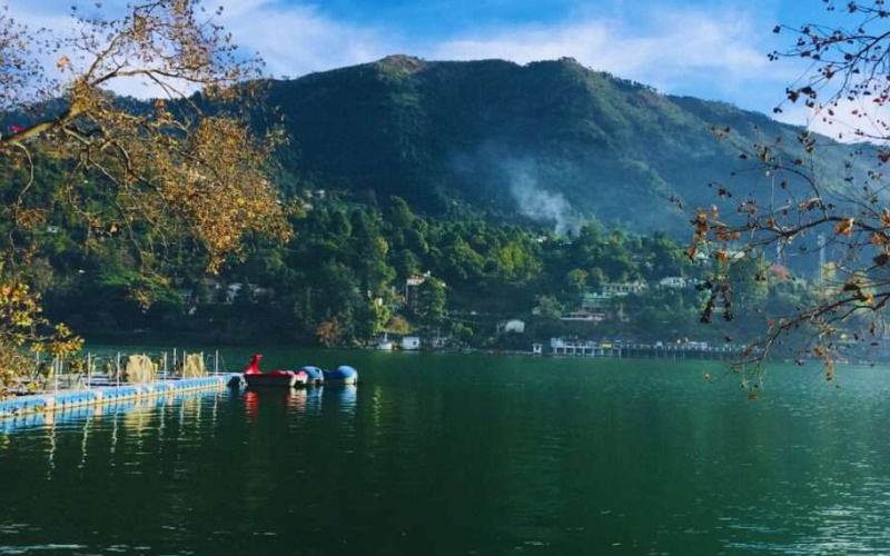 A panoramic shot of Naini Lake surrounded by hills.