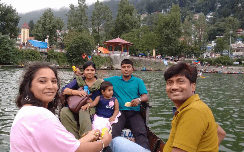 Happy family enjoying boating at Naini Lake