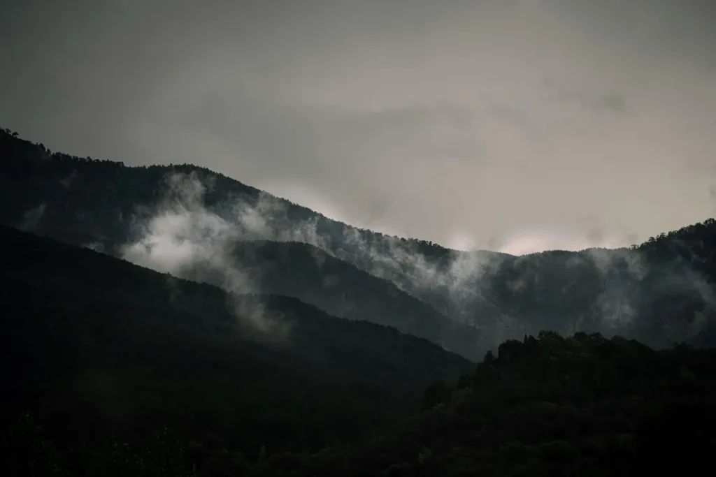 Misty hills of Nainital covered in clouds during a rainy morning, capturing the natural beauty and changing weather in Nainital.