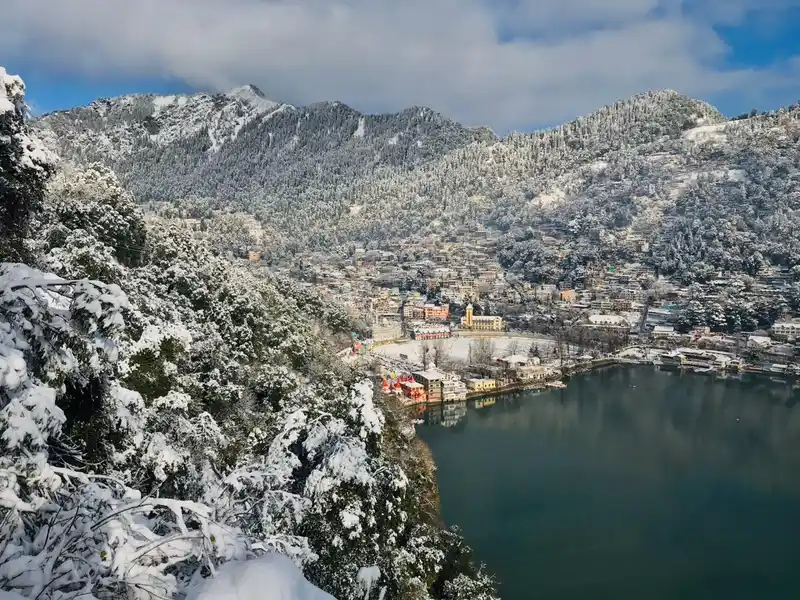 A photo of snow falling over Naini Lake.