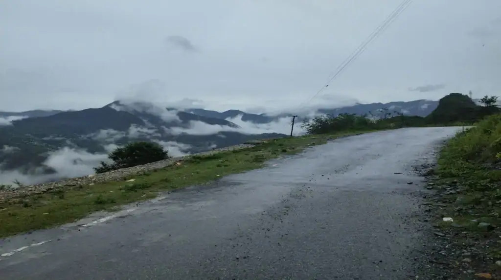Delhi to Nainital road trip through scenic mountain roads and cloudy hill views in Uttarakhand