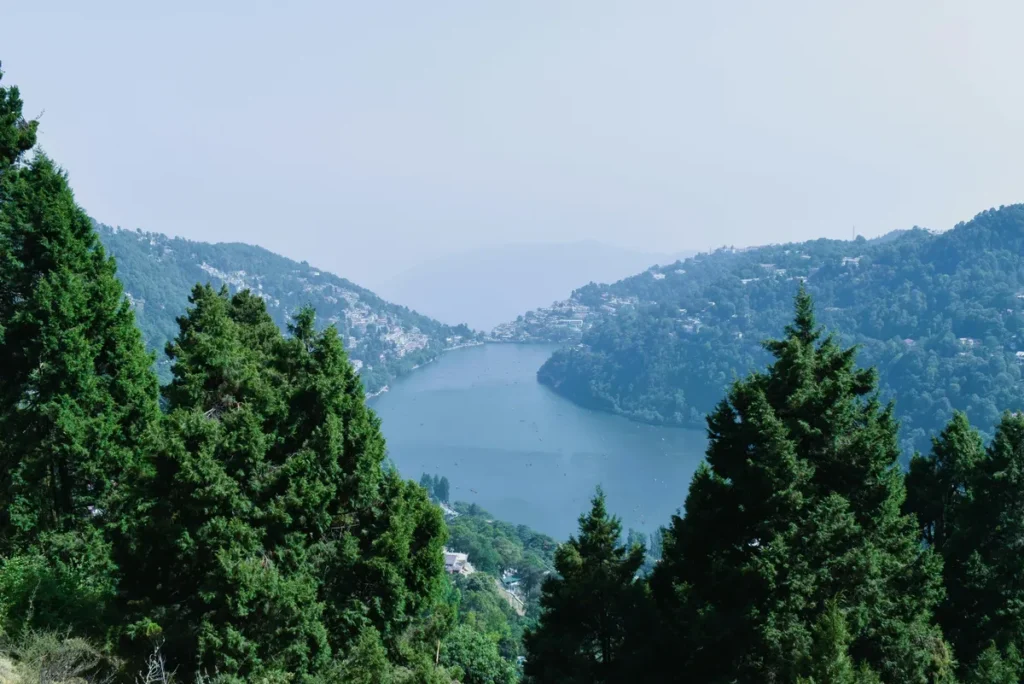 Nainital Mall Road area view with Naini Lake surrounded by hills and pine trees