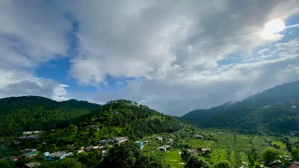 Best time to visit Nainital in June 2026 with cloudy skies and green mountain views