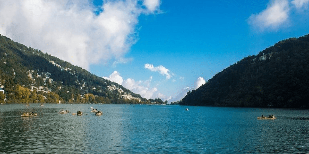 A scenic shot of Nainital Lake with hills in the background