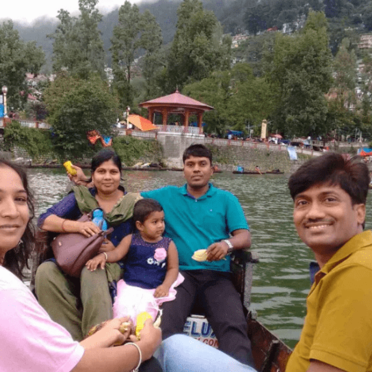 Happy family enjoying boating at Naini Lake