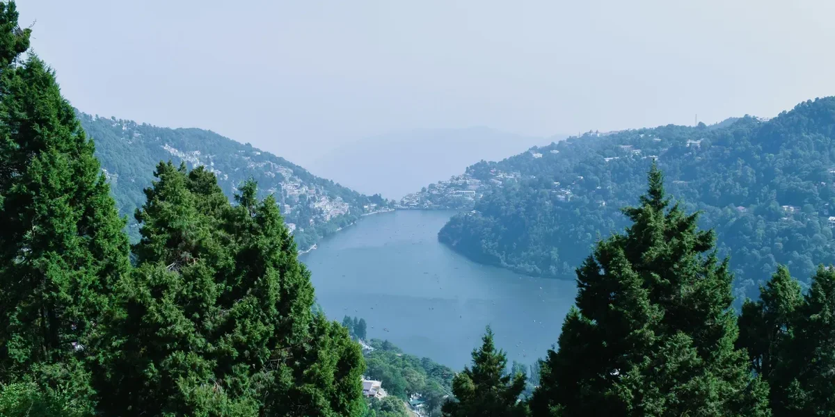 Nainital Mall Road area view with Naini Lake surrounded by hills and pine trees