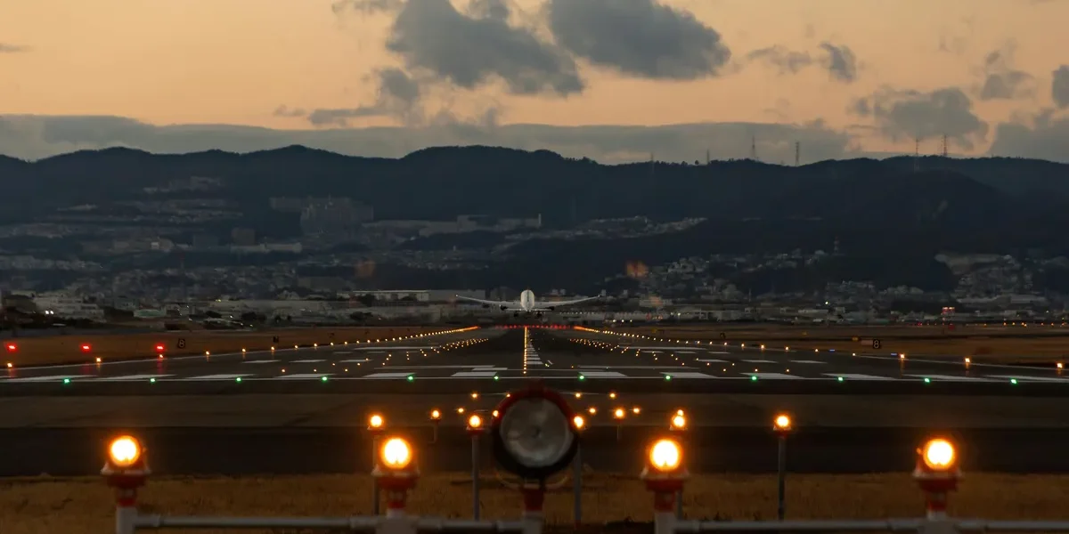 Aerial view or photo of Pantnagar Airport with planes or surrounding hills.